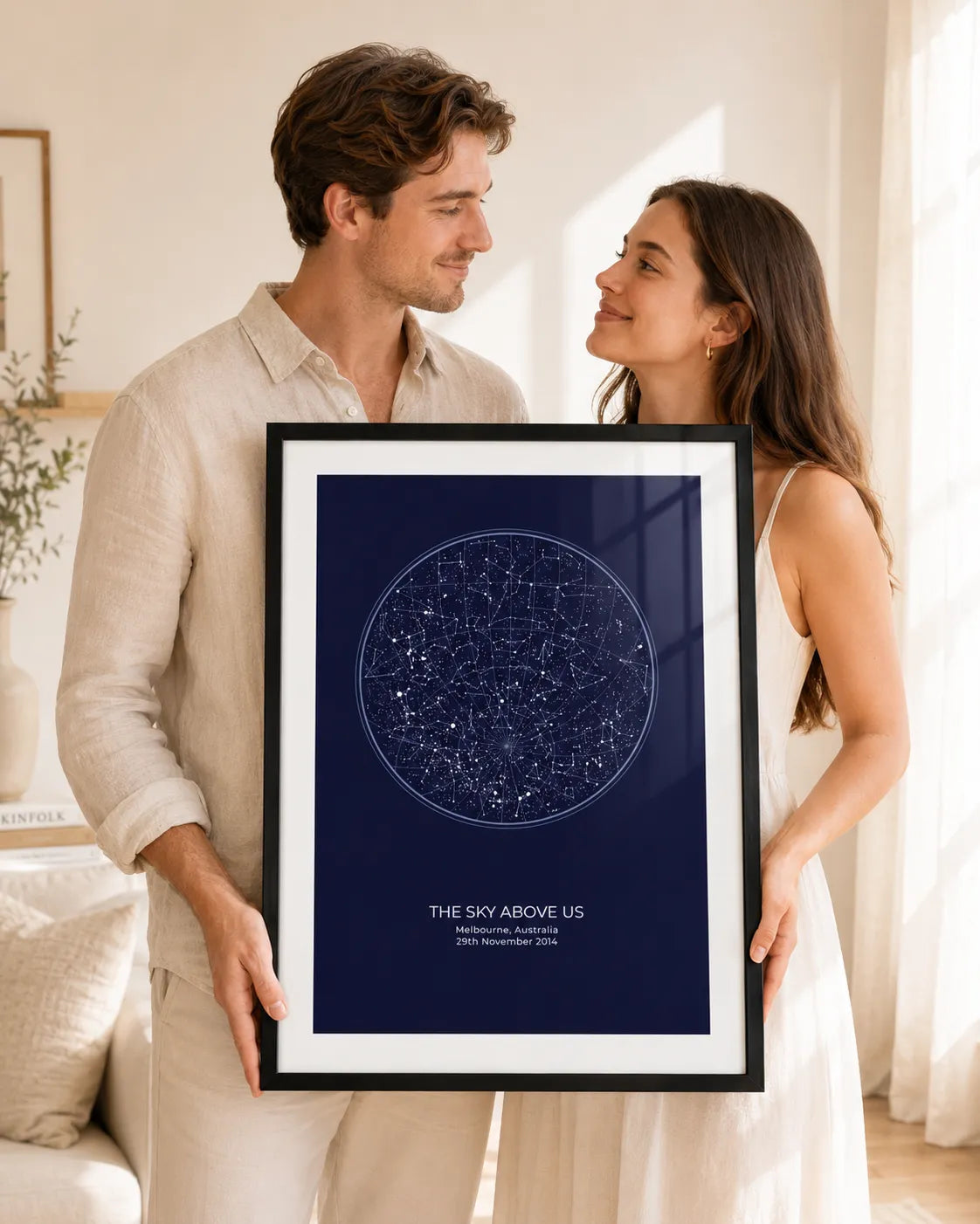 Framed star map print on a shelf