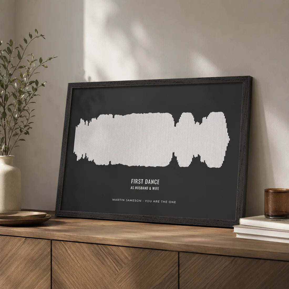 Couple with a framed voice print soundwave